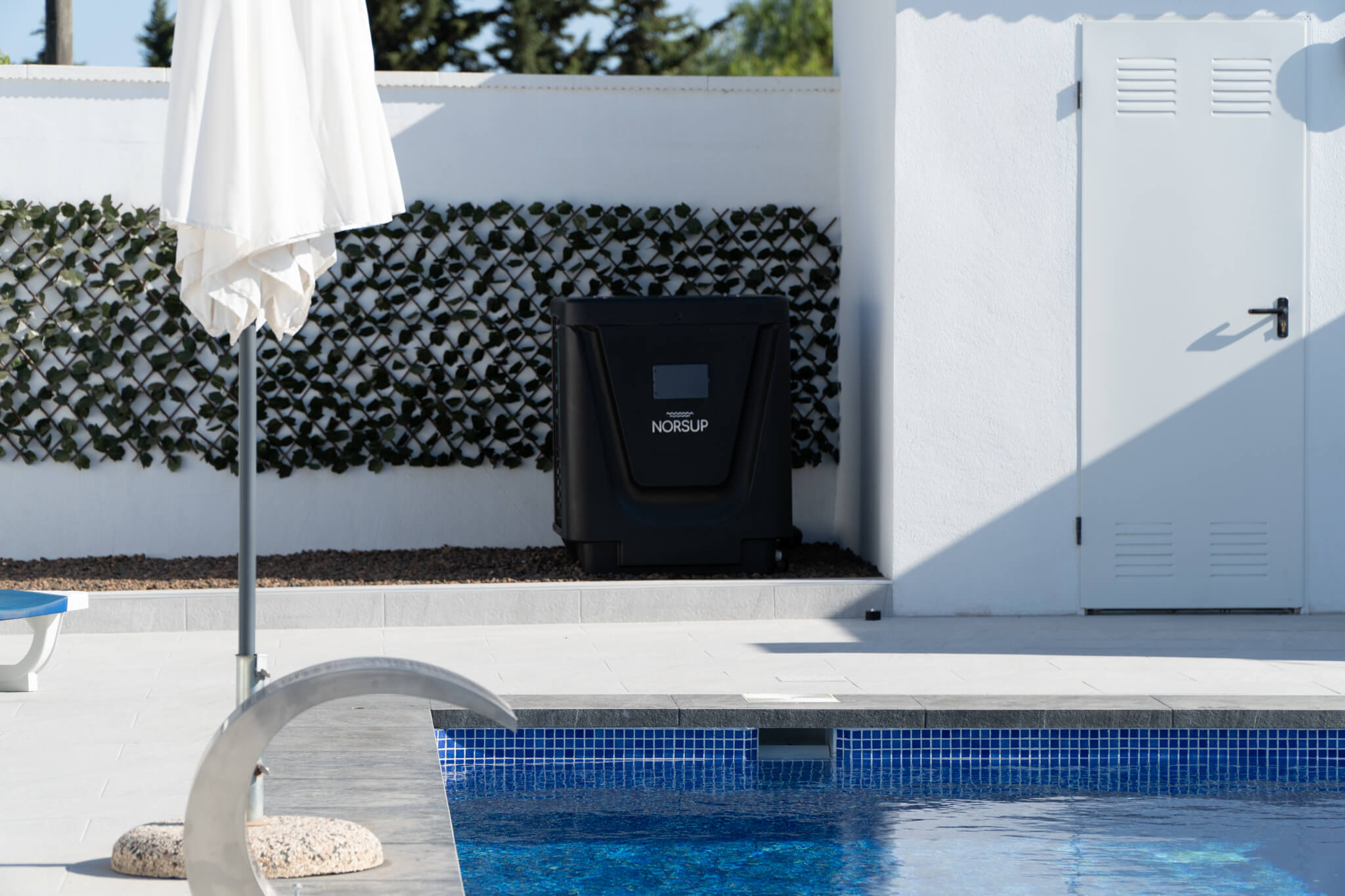 Norsup Vertical Heat pump next to a swimming pool